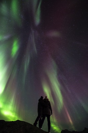 taking pictures of people under the northern lights